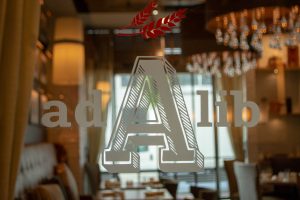 A view through the glass door into Ad Lib's private event dining room.